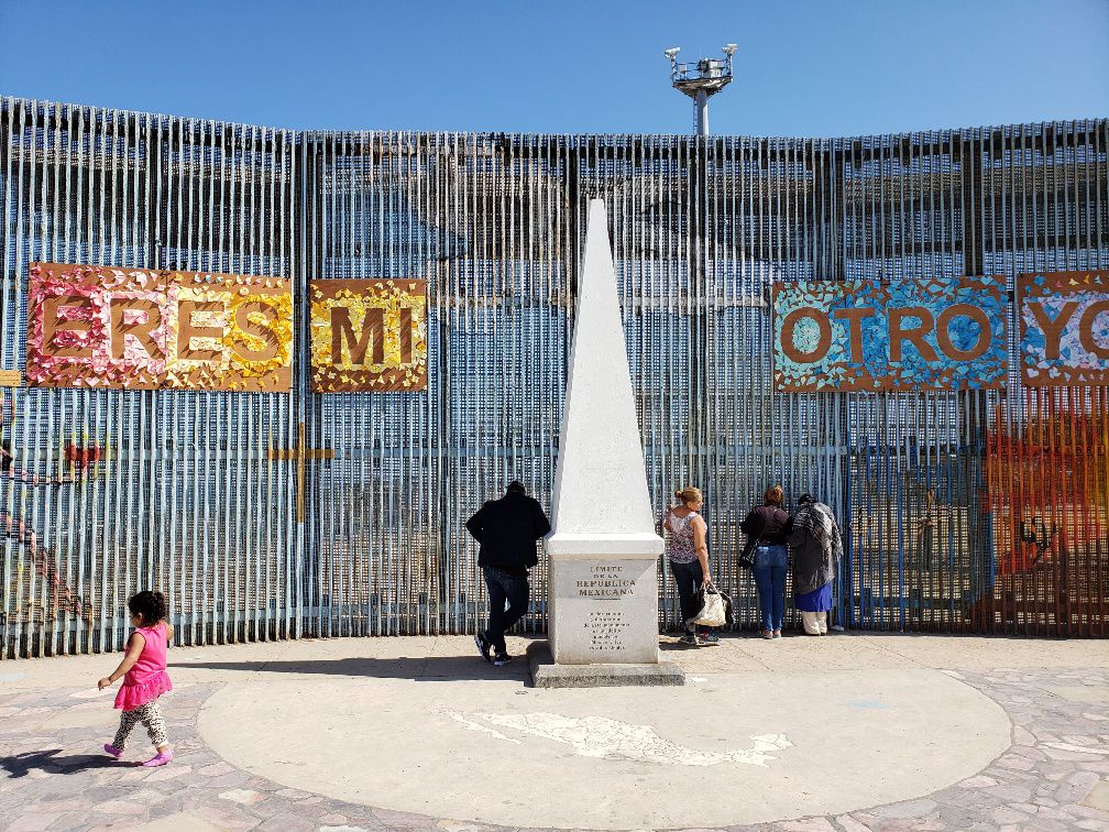 Mexican nationals waiting to talk to family members on the other side of the border.